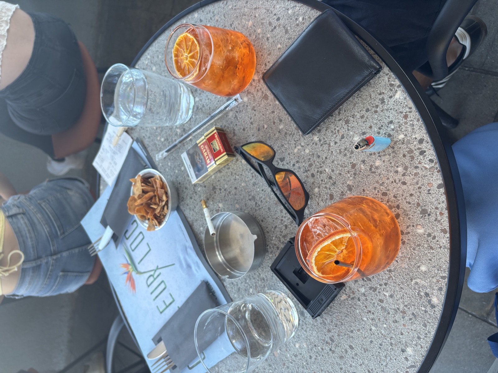 Aperols on a terrace, in the late afternoon light