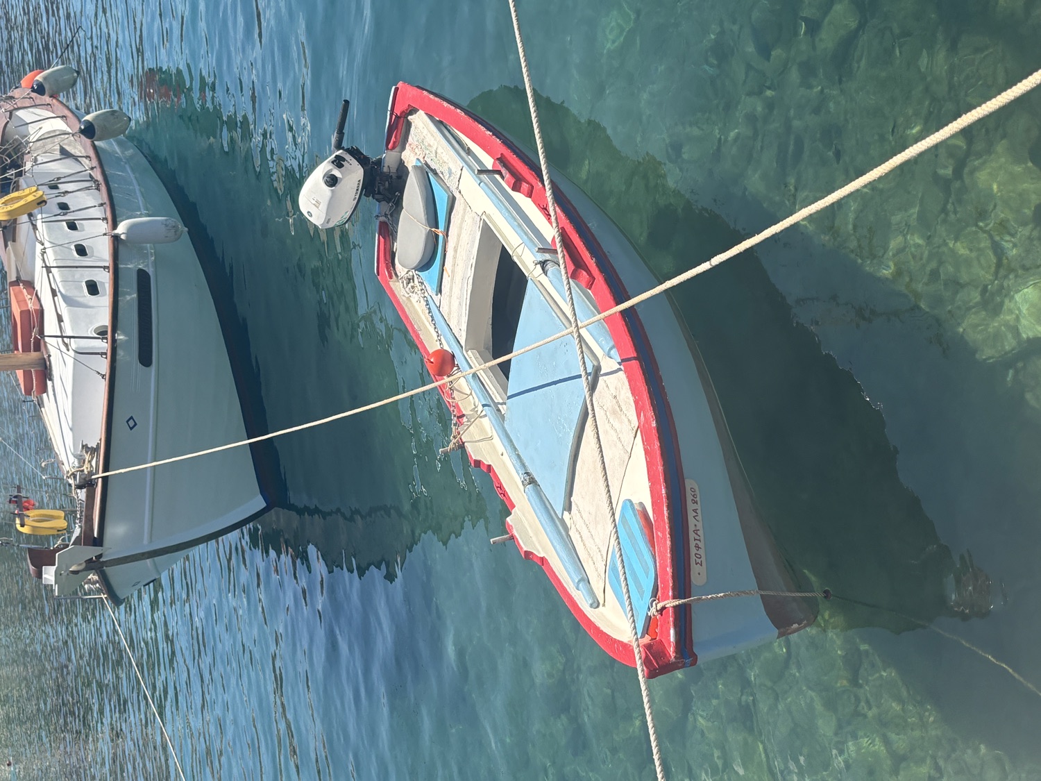 Two traditional Greek boats on crystal clear water